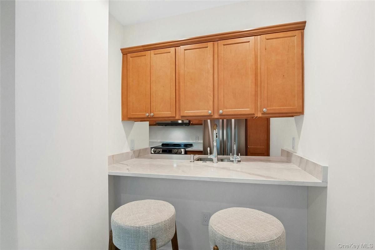 Breakfast bar with seating area open to kitchen