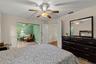 Spacious primary bedroom retreat featuring a bright and airy layout with a comfortable sitting area, creating the perfect space for relaxation and pri