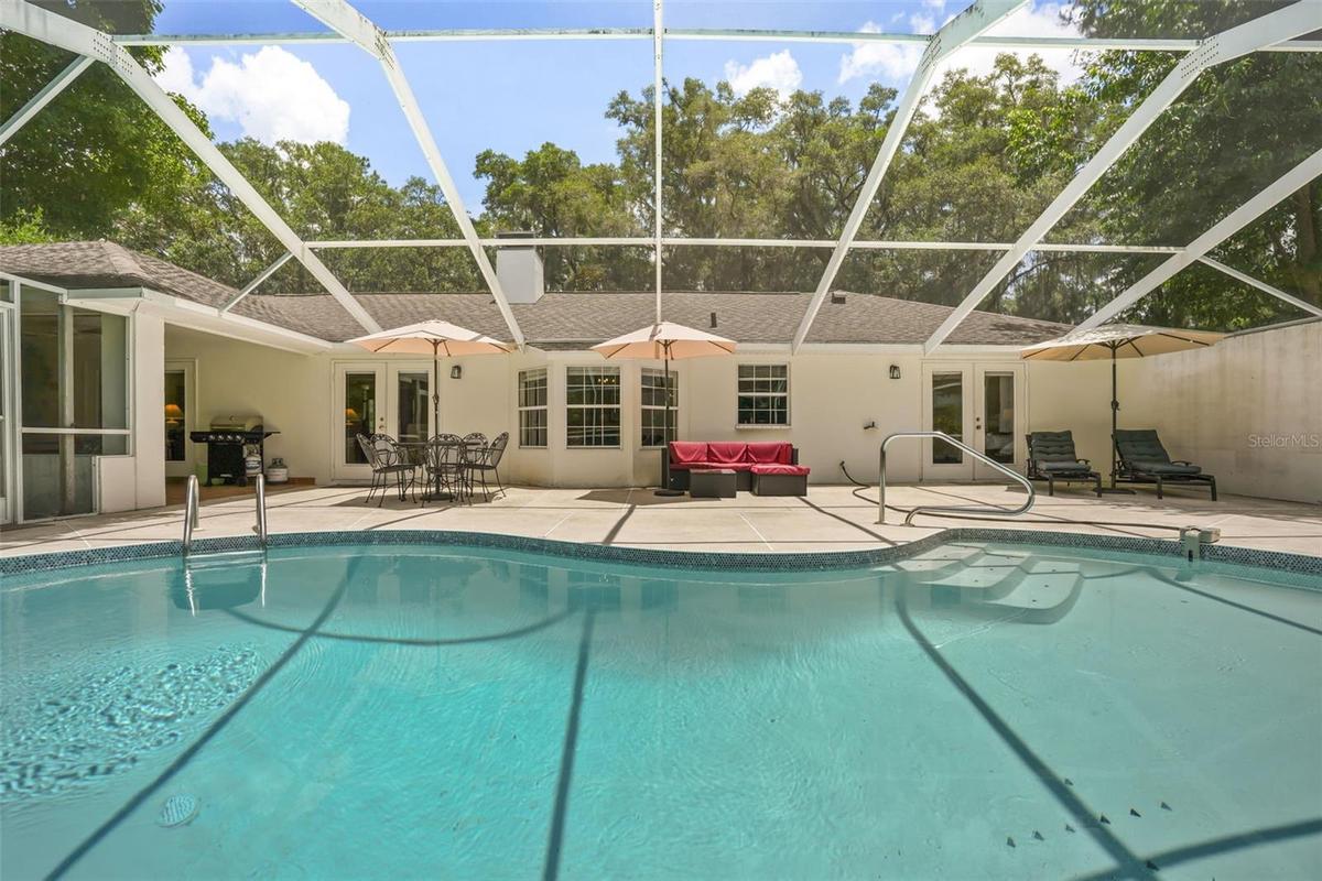 Resurfaced heated pool with screened enclosure, perfect for relaxing after a day at the barn.