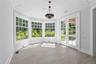 Unfurnished sunroom with healthy amount of natural light, french doors, and crown molding