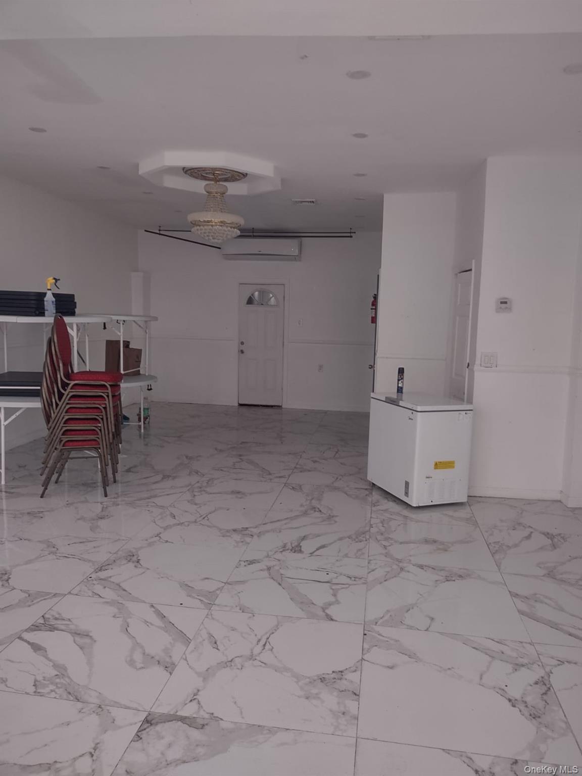 Spare room featuring light marble finish flooring