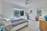 Carpeted bedroom with ceiling fan, access to outside, and multiple windows