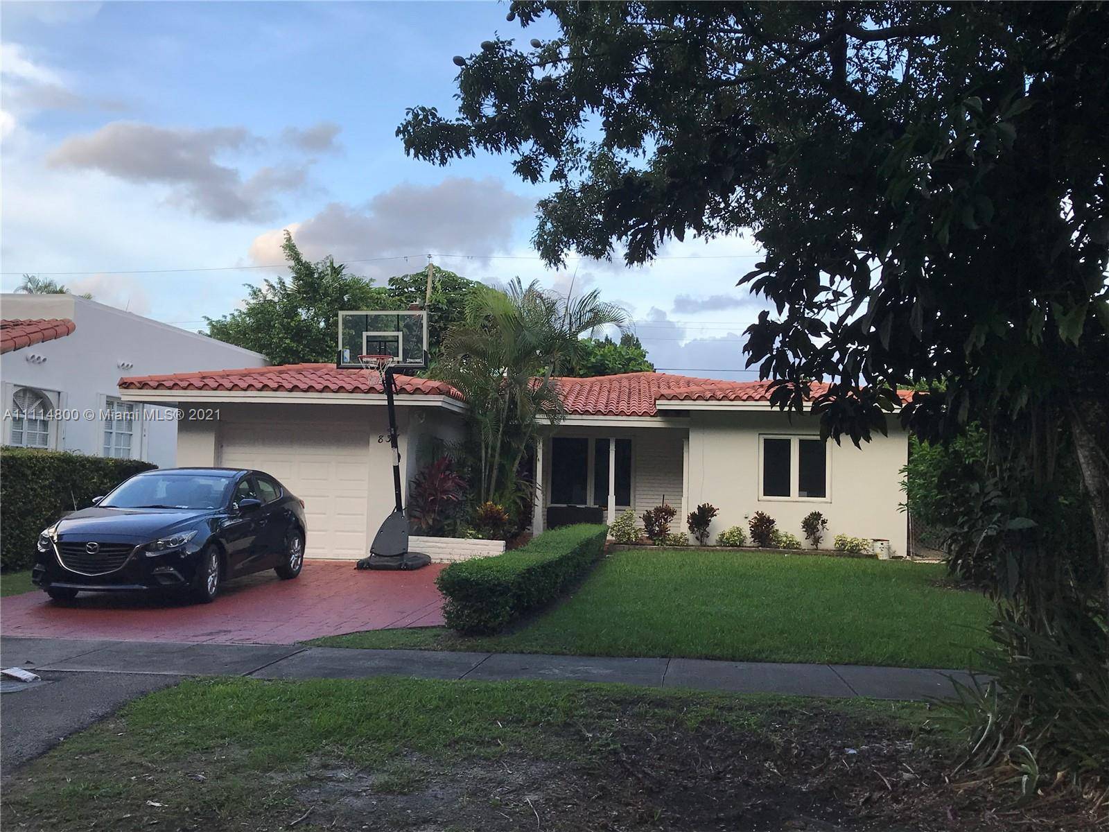 This Charming Coral Gables single family home sits on a quiet street among a beautiful canopy of mature Oak lined trees.
