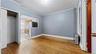 Unfurnished bedroom with light wood-style flooring, ornamental molding, freestanding refrigerator, and radiator heating unit