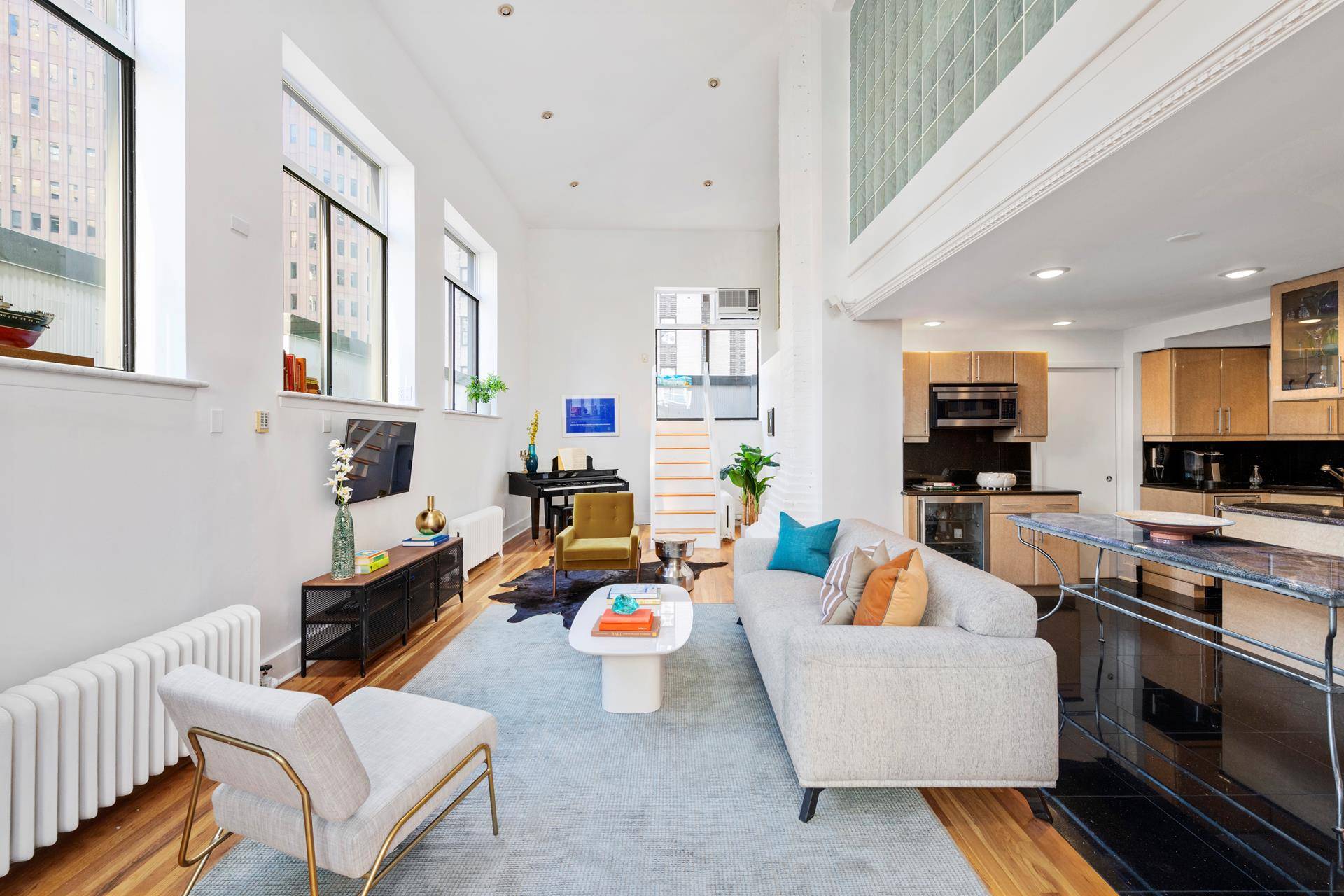 The stunning duplex House in the Sky at 26 Beaver St enjoys exceptional privacy, a wraparound terrace, and fantastic architectural views of lower Manhattan and beyond.
