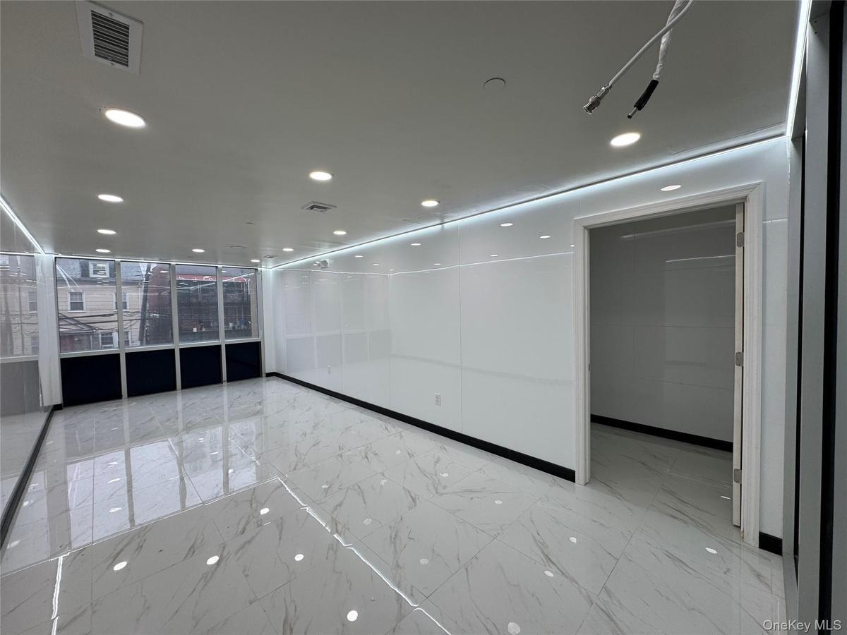 Empty room with marble finish floor, visible vents, and recessed lighting