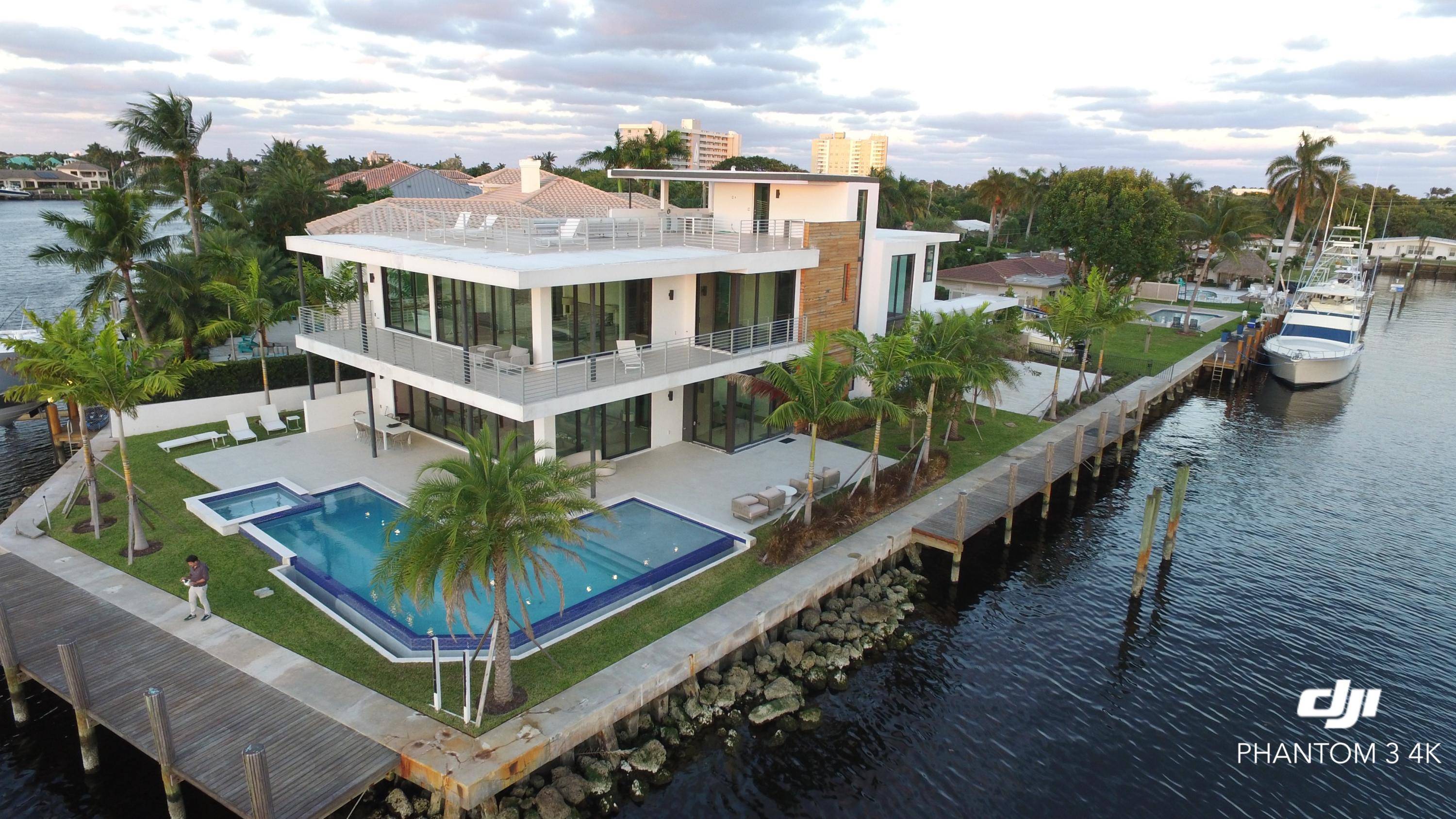 Unique opportunity to enjoy this New 3 levels Modern Intracoastal Point Lot property planted on 240 feet water frontage in Hillsboro Shores.
