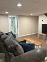 Finished room featuring wood-finish flooring, recessed lighting, and neutral wall tones.Apt. #1