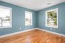 Empty room with wood finished floors and plenty of natural light