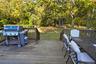 Wooden deck featuring grilling area and outdoor dining area