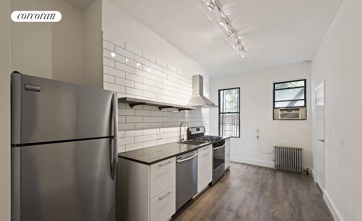 Spacious townhouse, one bedroom plus home office apartment one easy flight up, on a picturesque tree lined block in Greenpoint.