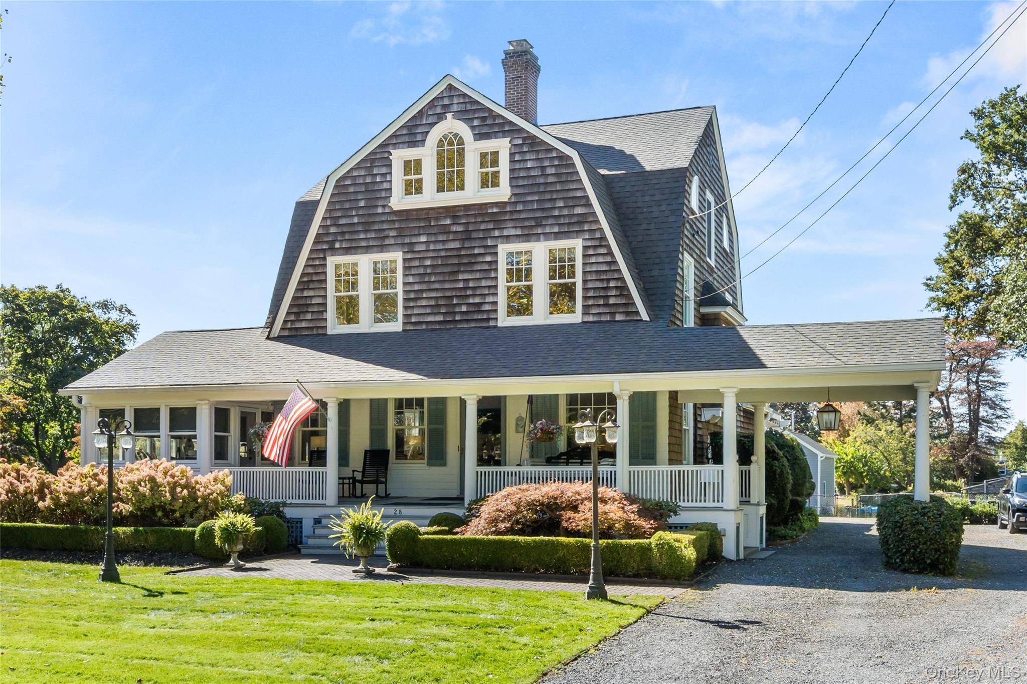 Welcome to 28 S. Montgomery Avenue a distinguished Dutch Colonial set on nearly an acre of waterfront property in Bay Shore.