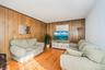 Living space featuring wood-finish flooring and paneling