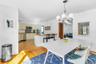 Dining space with a chandelier and light hardwood / wood-style flooring