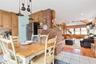 Dining space with wood walls, recessed lighting, light tile patterned floors, and stairs