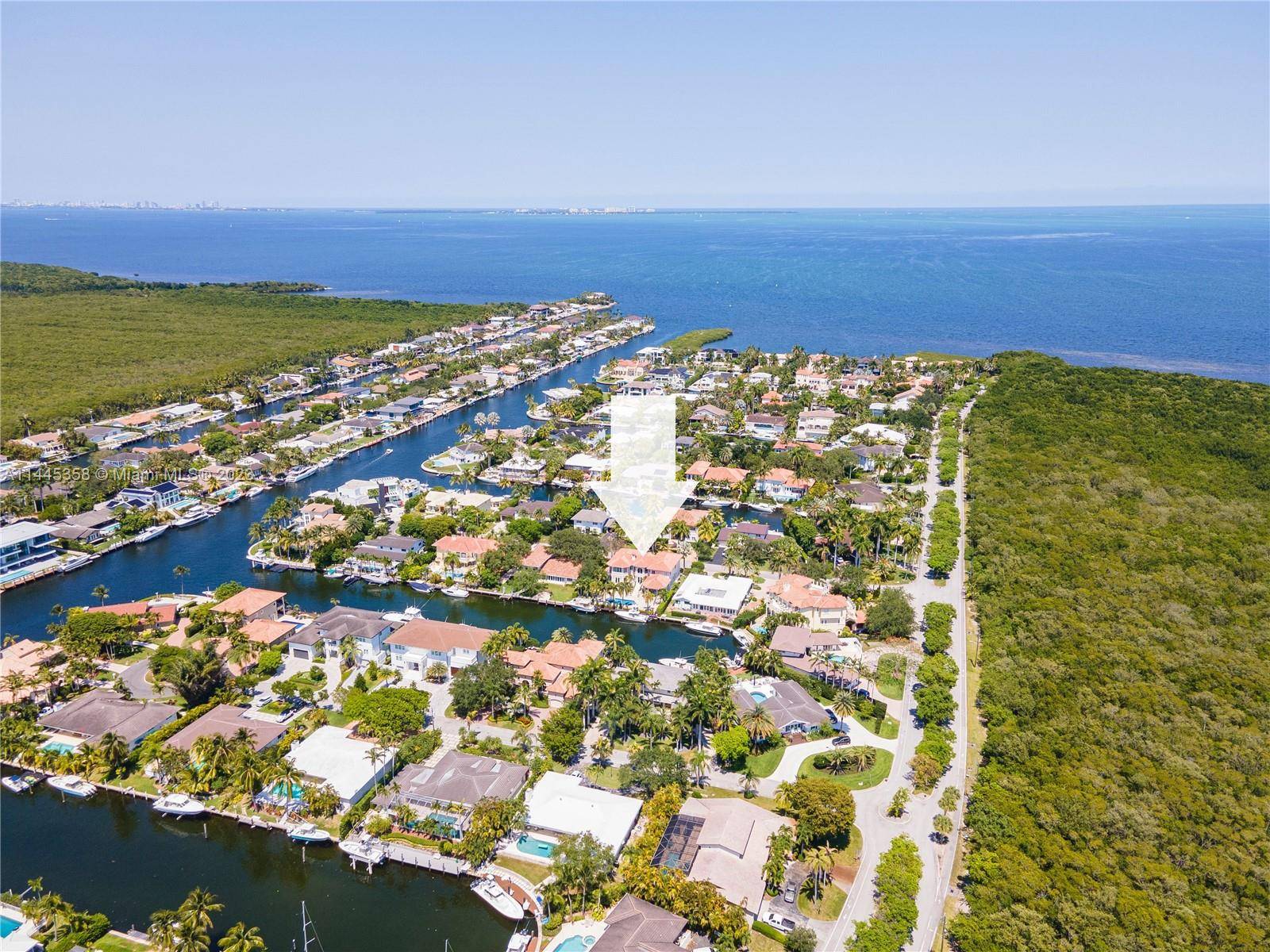2002 construction luxury waterfront property in cul de sac street nestled in gated Gables by the Sea boasts 100' direct ocean access.
