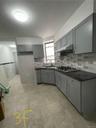Kitchen featuring gray cabinets, dark countertops, and stainless steel gas cooktop