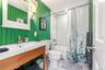 Full bathroom with shower / tub combo, vanity, and light tile patterned floors