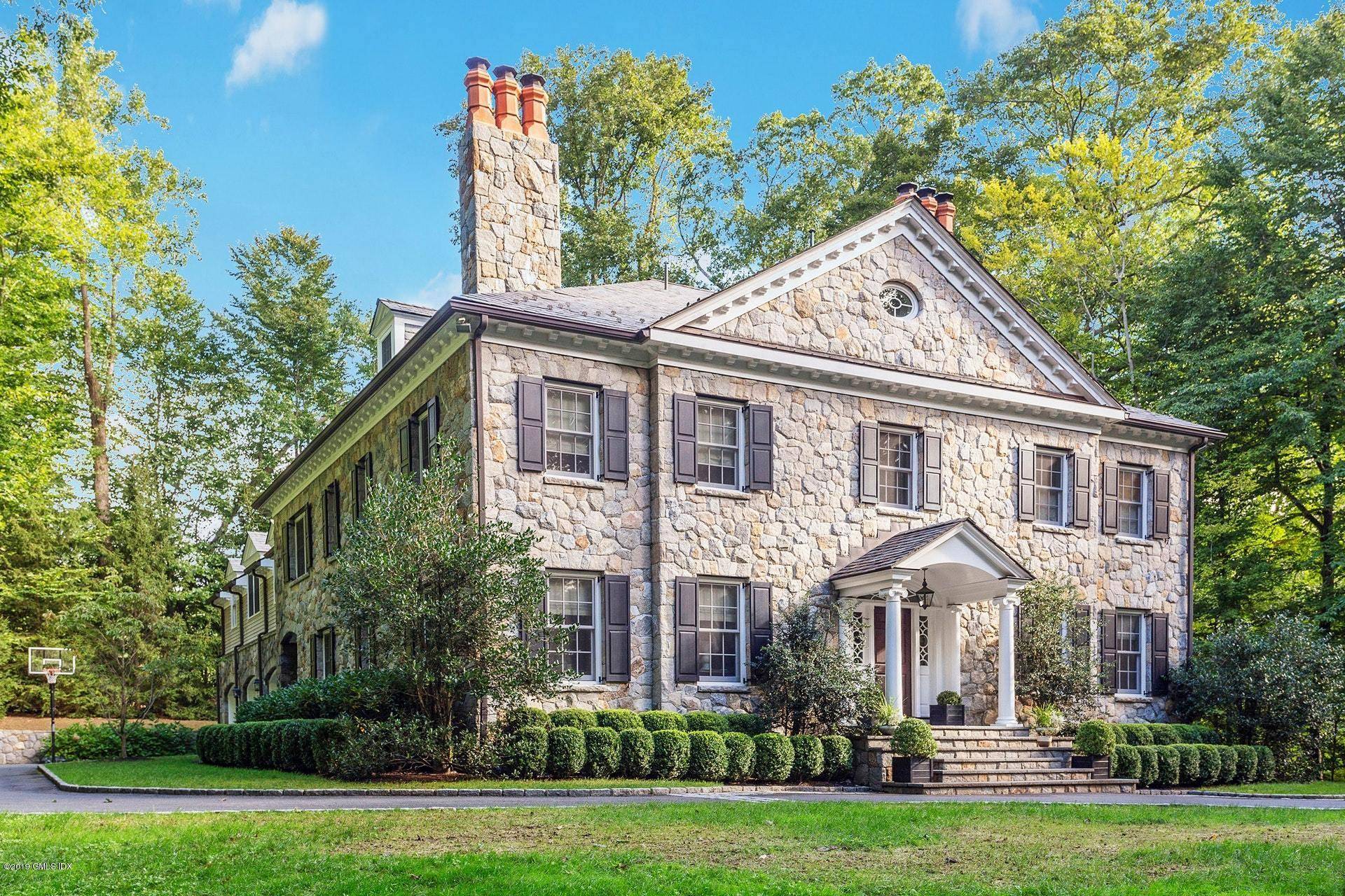Elegant custom stone Georgian home secluded at end of cul de sac off Round Hill Road.