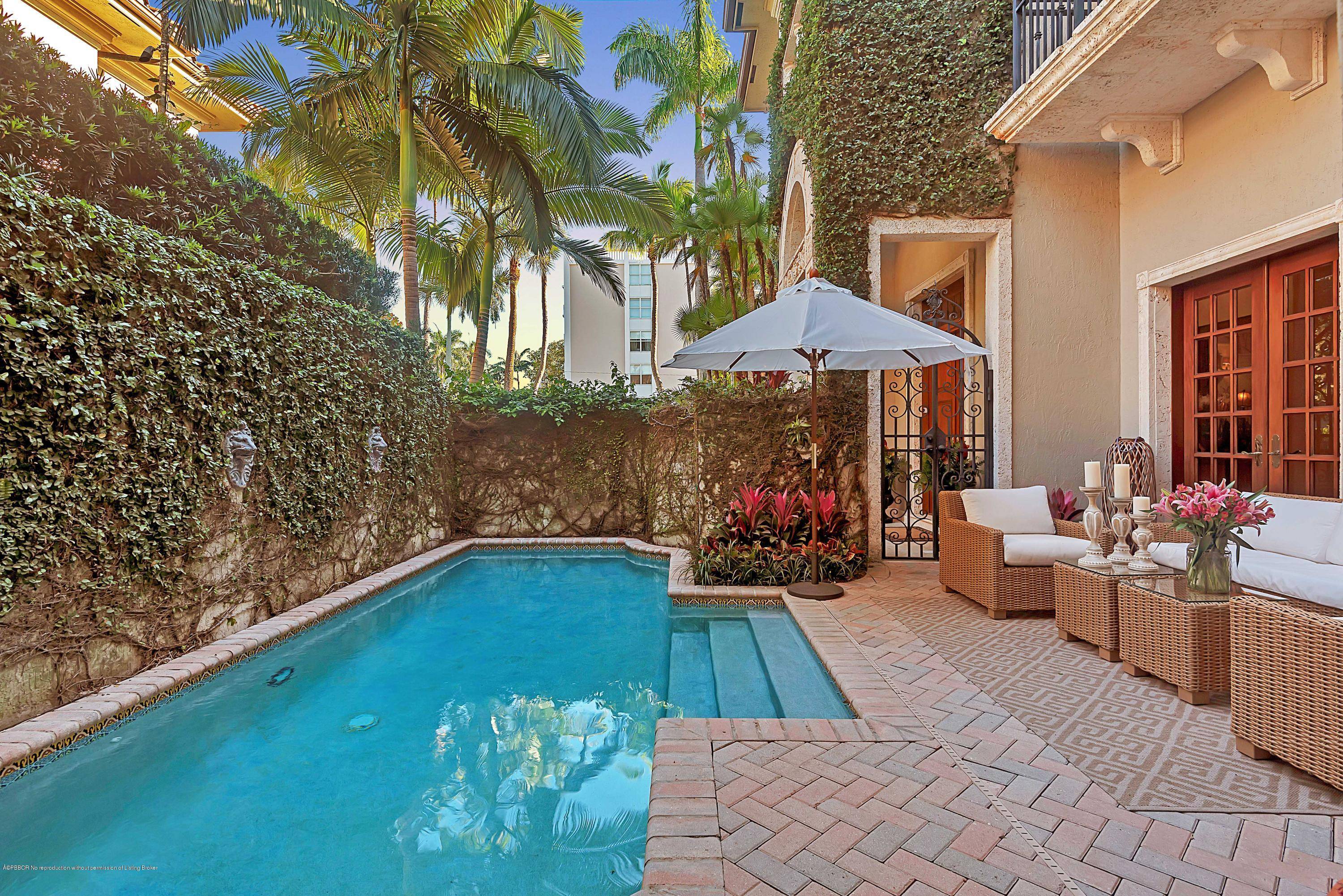 Just beyond the iron gate is a rare opportunity to own an outstanding townhouse on one of the best streets in Palm Beach.