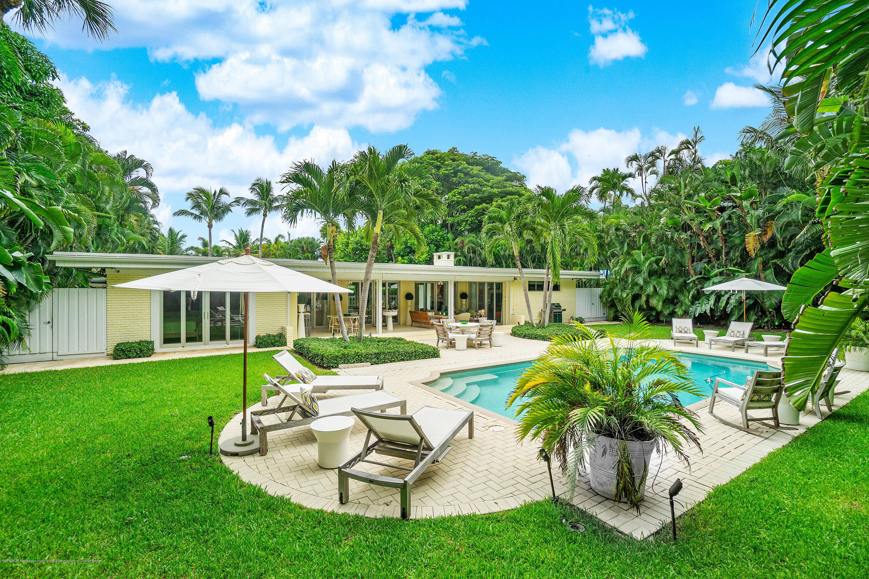 This Mid Century Modern Gem on tropical Hypoluxo Island occupies a double lot surrounded by lush landscaping.