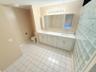Spacious bathroom featuring a dual vanity with white cabinetry, white countertops, and undermount sinks