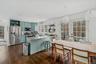 Kitchen featuring open shelves, stainless steel appliances, green cabinets, french doors, and a peninsula