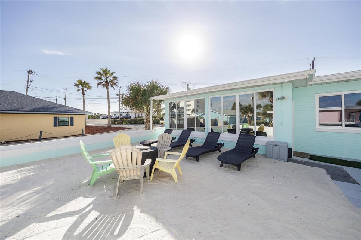 Back yard with beach sand, beach view, grill, and bar top