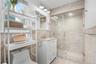 Full bathroom featuring a glass-enclosed shower with recessed lighting, a built-in shower niche, and a rain showerhead