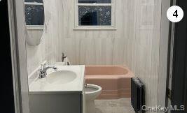 Full bathroom featuring radiator, vanity, toilet, and shower / tub combination