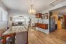 Dining area featuring lofted ceiling, hanging lights, wood finish floors, arched walkways, and a ceiling fan