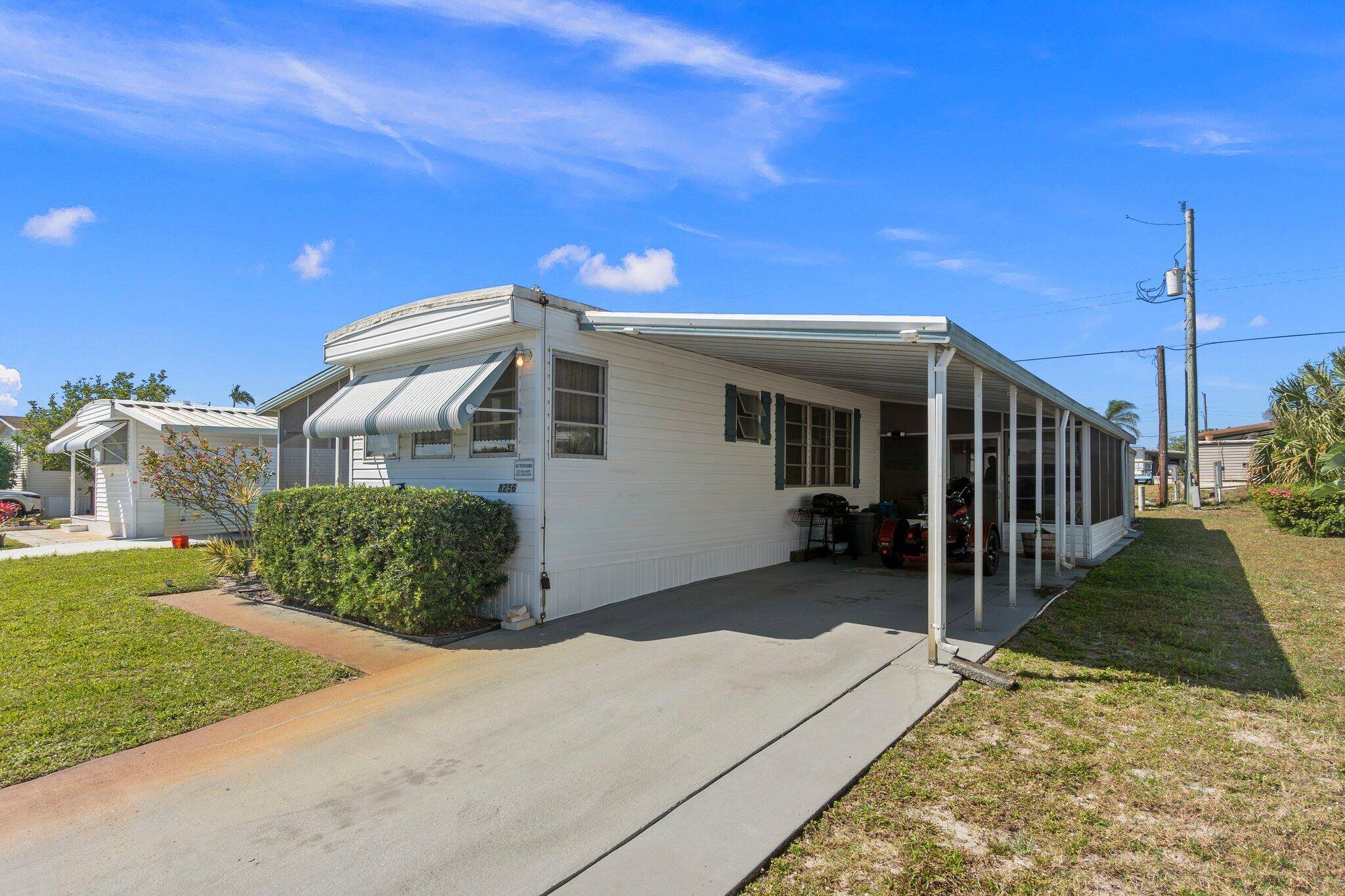 Welcome home to this beautifully maintained mobile home in the community of Ridgeway in Hobesound, FL.