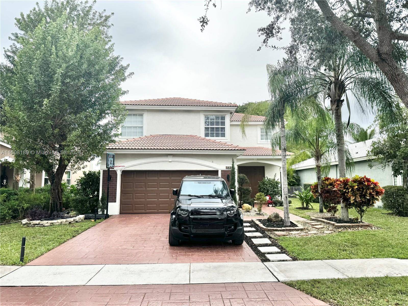 Nestled within the secure confines of Parkside Estates, a gated community in Parkland, stands a beautiful two story house with 5 bedrooms and 2.