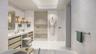 Artist Rendering. Luxurious primary bath featuring custom vanities, marble floors, walls and shower and lavish freestanding soaking tub.
