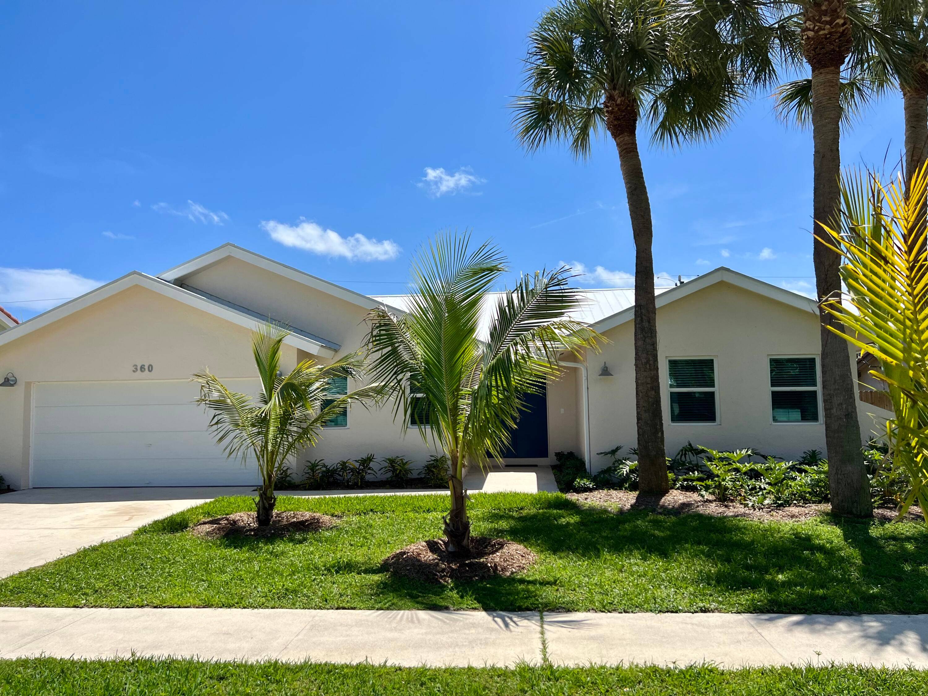 This recently remodeled spacious, open floor plan shows off 15ft vaulted ceilings w skylights, new impact windows doors and ceramic tile throughout.