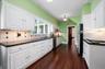 Kitchen accessed by side porch and opens to butler's pantry