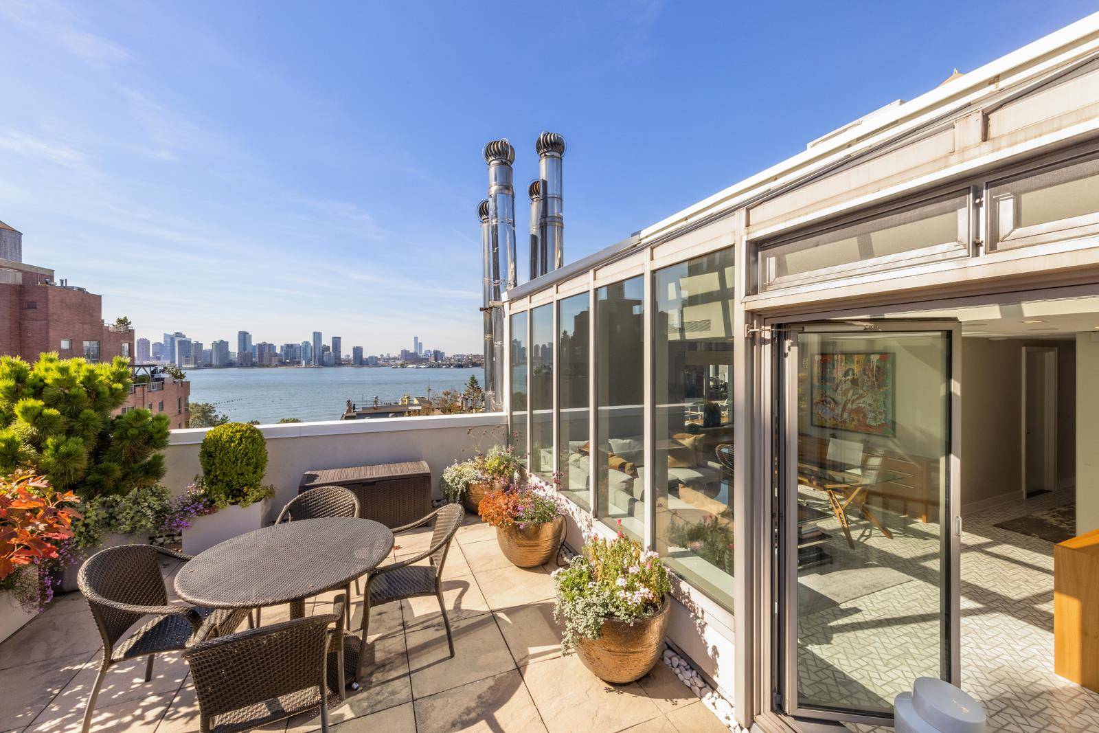 Rare, just renovated duplex penthouse home with three private outdoor spaces and 360 degree views of the Hudson River and city skyline in 359 West 11th Street, a boutique full ...