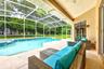 Step through the sliders into your own PRIVATE OUTDOOR OASIS where a screened lanai, IN-GROUND POOL, SPA and PATIO AREA create the perfect setting for