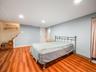 Bedroom with light wood finished floors and recessed lighting