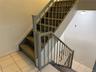 Stairs with tile patterned floors