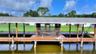 HUGE covered boathouse with screened room. One side has a lift.