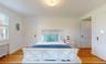 Bedroom featuring crown molding, radiator, and light hardwood / wood-style floors