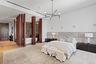 Bedroom featuring a notable chandelier, wood finished floors, and recessed lighting