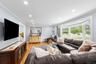 Living room with ornamental molding, light wood-style floors, recessed lighting, and a baseboard radiator
