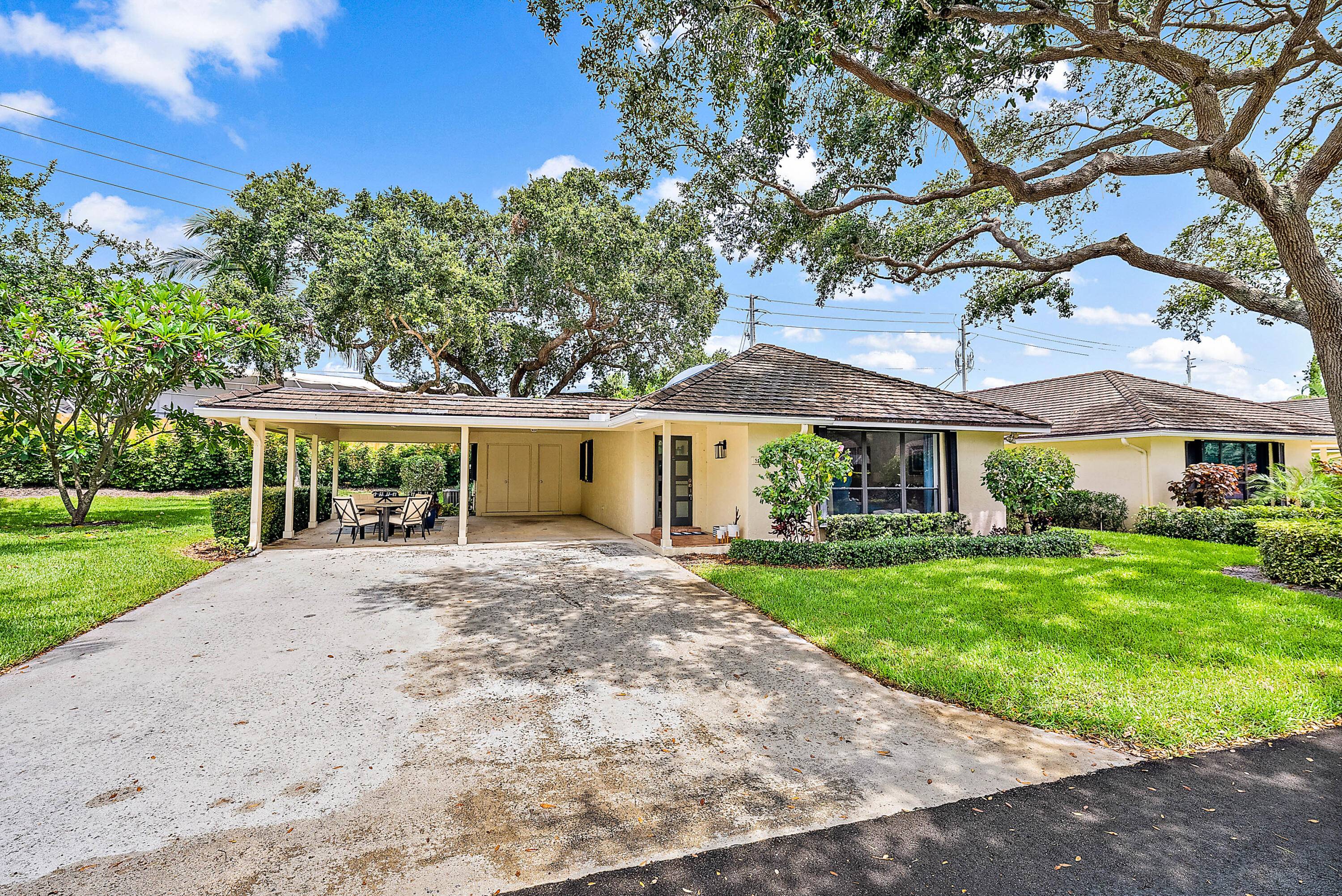 Charming one story villa located at the end of a quiet street within the gated waterfront community of Twelve Oaks.