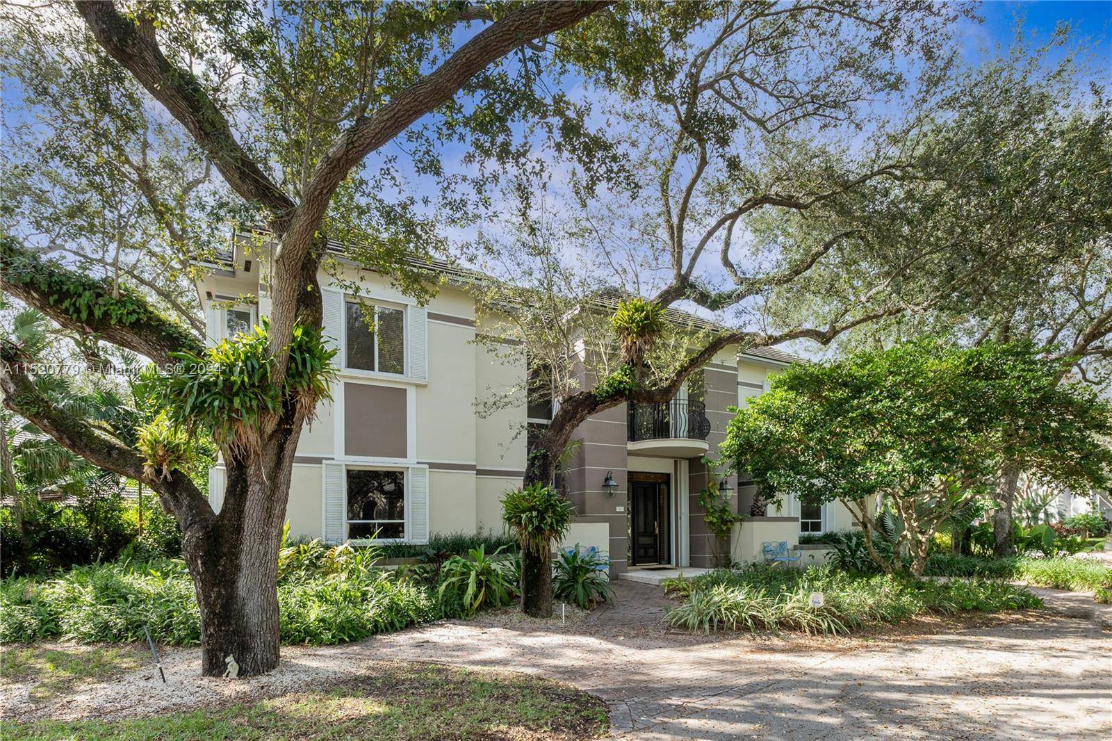 This French style transitional executive home located in the private, gated community of exclusive Cutler Oaks with 24 residences.
