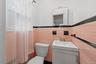Immaculate half bath in primary bedroom with window, freshly painted.