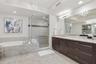 Luxurious primary bath with dual vanities, soaking tub, and walk-in shower.