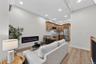 Open-concept living area featuring an electric fireplace, wood-finish flooring, recessed lighting, and a kitchen with wood cabinetry and stainless ste