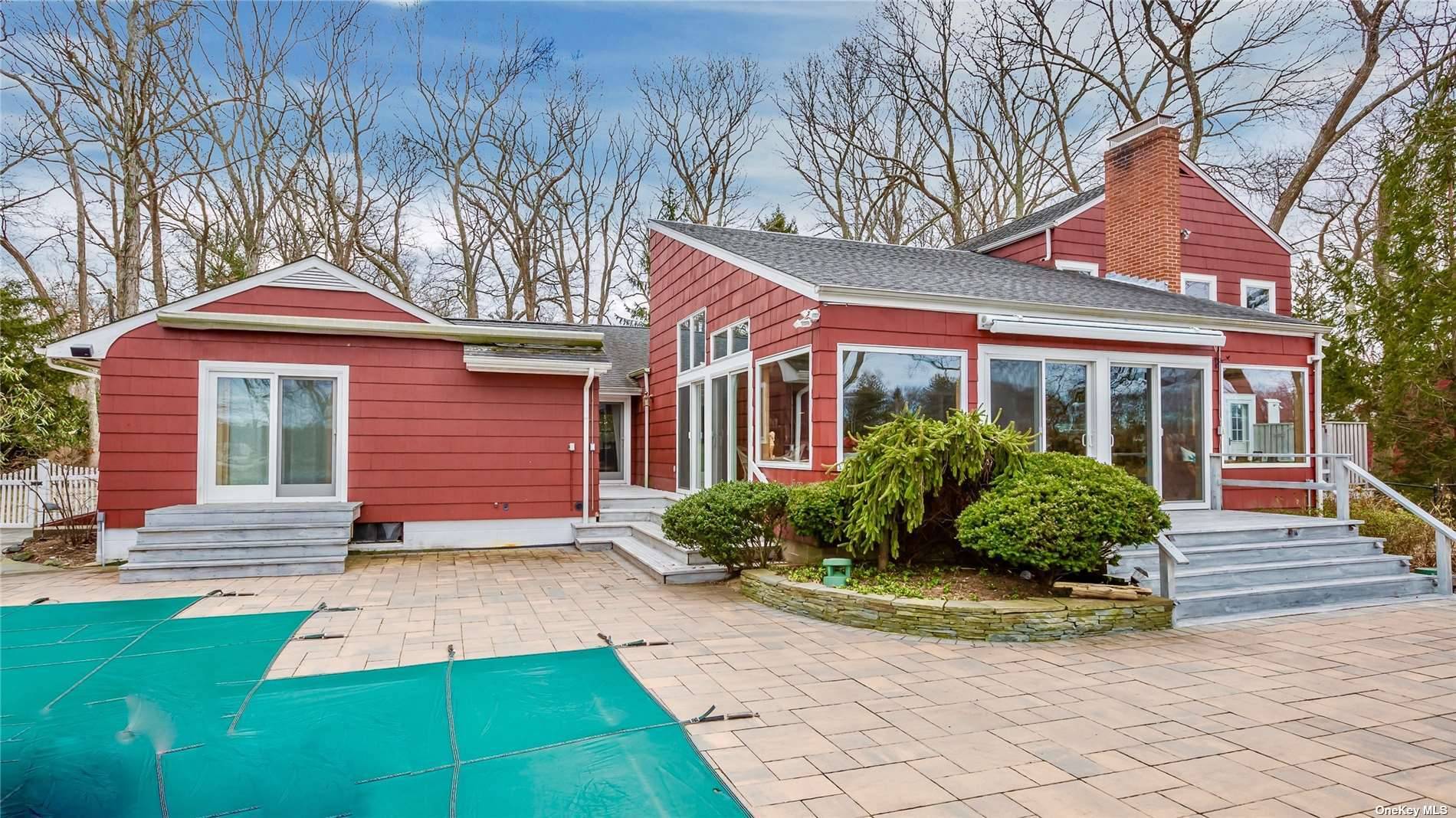 This fabulous North Fork waterfront setting features a heated waterside saltwater pool, hot tub, fire pit, dock and charming private beach area.